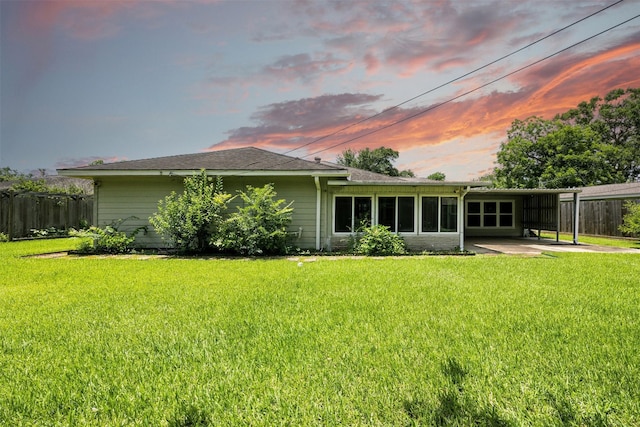 3014 Castlewood St, Houston, TX 77025 - back of house at dusk with a carport, a sunroom, and roof with shingles