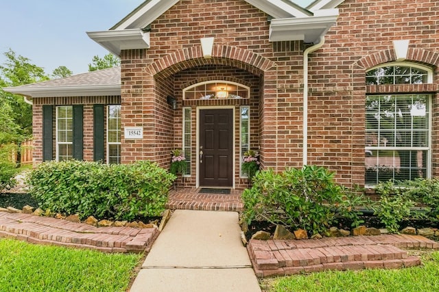15542 Stoneridge Park Ln, Cypress, TX 77429 - view of exterior entry featuring brick siding and roof with shingles