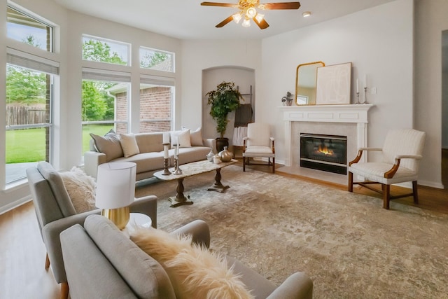 15542 Stoneridge Park Ln, Cypress, TX 77429 - living room featuring ceiling fan, wood finished floors, and a fireplace with flush hearth