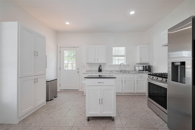 4401 Canal St, Houston, TX 77011 - kitchen featuring appliances with stainless steel finishes, healthy amount of natural light, white cabinets, and recessed lighting