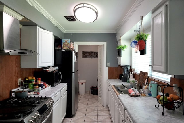 8606 S Friendship Rd, Houston, TX 77080 - kitchen with wall chimney range hood, stainless steel range with gas stovetop, light countertops, white cabinets, and ornamental molding