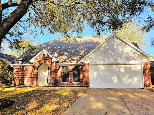 7715 Lobera Dr, Houston, TX 77083 - ranch-style house featuring brick siding, an attached garage, concrete driveway, and a shingled roof