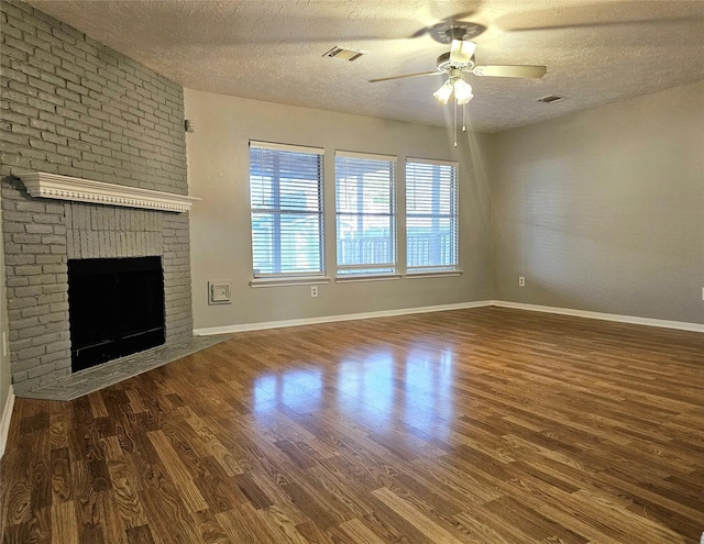7715 Lobera Dr, Houston, TX 77083 - unfurnished living room featuring a textured ceiling, wood finished floors, a ceiling fan, and a fireplace