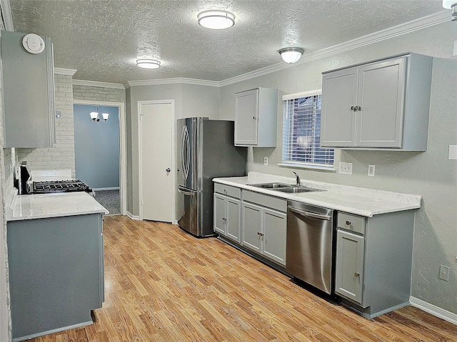 7715 Lobera Dr, Houston, TX 77083 - kitchen featuring appliances with stainless steel finishes, gray cabinetry, light wood-style flooring, a textured ceiling, and crown molding