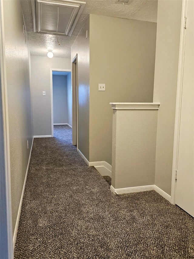 7715 Lobera Dr, Houston, TX 77083 - hallway with attic access, carpet, and a textured ceiling