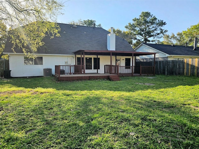 7715 Lobera Dr, Houston, TX 77083 - rear view of house featuring a fenced backyard, a wooden deck, a chimney, and a shingled roof