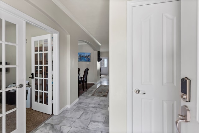 6605 Fallen Breeze Ln, Dickinson, TX 77539 - corridor featuring french doors, arched walkways, crown molding, and light marble finish floors