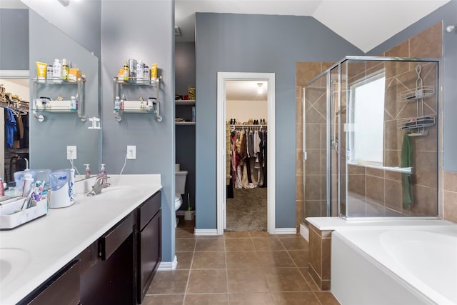 6605 Fallen Breeze Ln, Dickinson, TX 77539 - bathroom with a walk in closet, double vanity, a shower stall, and lofted ceiling