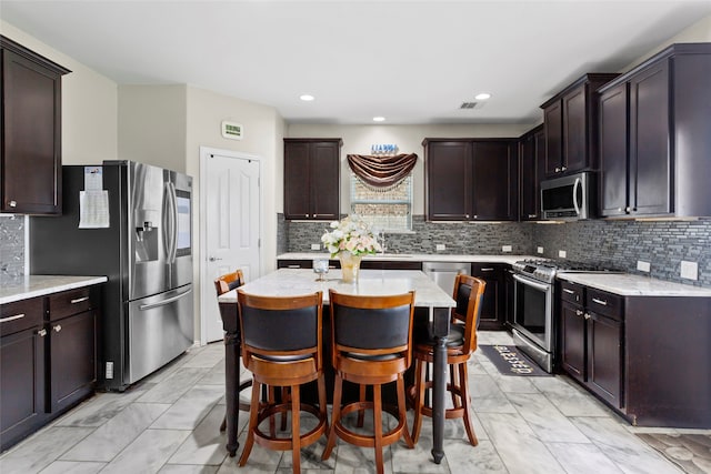 6605 Fallen Breeze Ln, Dickinson, TX 77539 - kitchen with appliances with stainless steel finishes, light marble finish flooring, tasteful backsplash, and recessed lighting