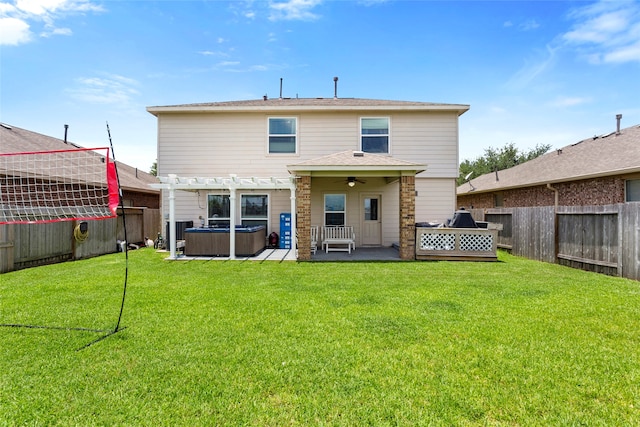 6605 Fallen Breeze Ln, Dickinson, TX 77539 - back of property featuring a hot tub, a fenced backyard, a patio area, a pergola, and ceiling fan