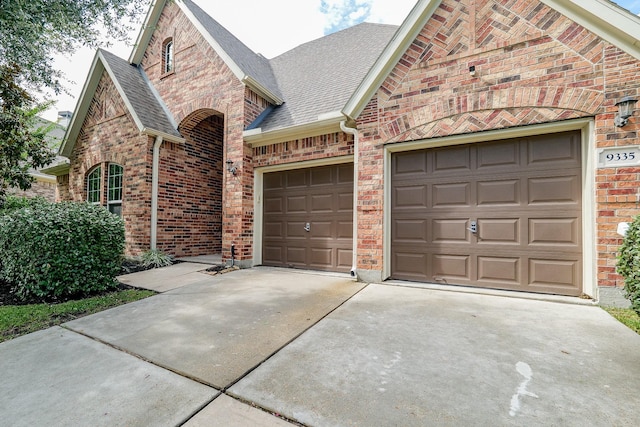 9335 Mystic Falls Ln, Humble, TX 77396 - view of front of home featuring driveway, an attached garage, and brick siding