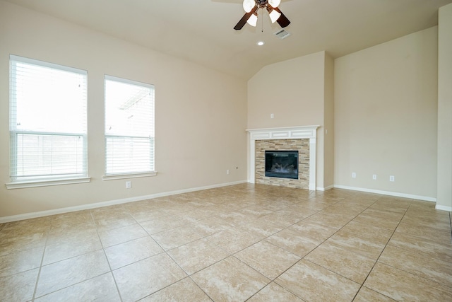 9335 Mystic Falls Ln, Humble, TX 77396 - unfurnished living room featuring ceiling fan, light tile patterned flooring, lofted ceiling, and a glass covered fireplace