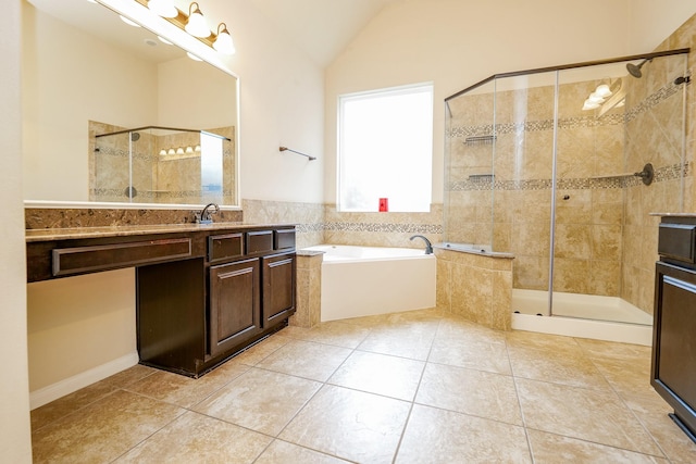 9335 Mystic Falls Ln, Humble, TX 77396 - bathroom featuring tile patterned floors, vanity, a bath, a stall shower, and vaulted ceiling