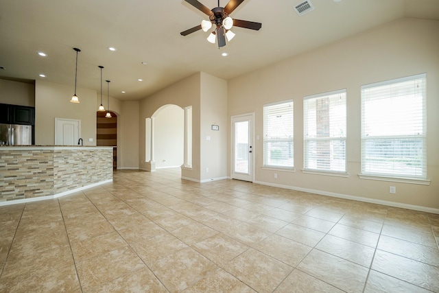 9335 Mystic Falls Ln, Humble, TX 77396 - unfurnished living room with arched walkways, light tile patterned flooring, recessed lighting, and ceiling fan