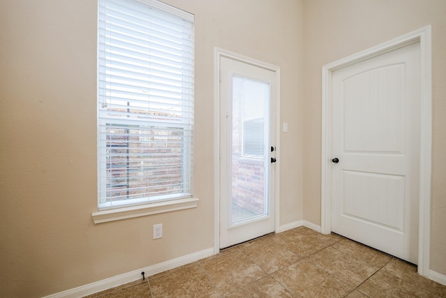 9335 Mystic Falls Ln, Humble, TX 77396 - doorway to outside with healthy amount of natural light and light tile patterned flooring