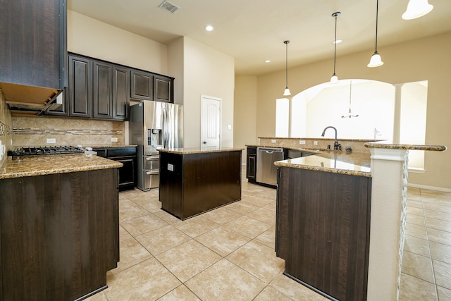 9335 Mystic Falls Ln, Humble, TX 77396 - kitchen featuring stainless steel appliances, a spacious island, backsplash, light tile patterned flooring, and recessed lighting