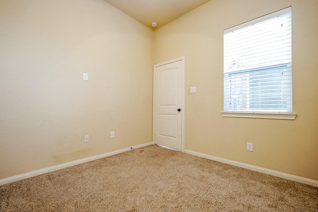 9335 Mystic Falls Ln, Humble, TX 77396 - spare room featuring carpet flooring, vaulted ceiling, and a smoke detector