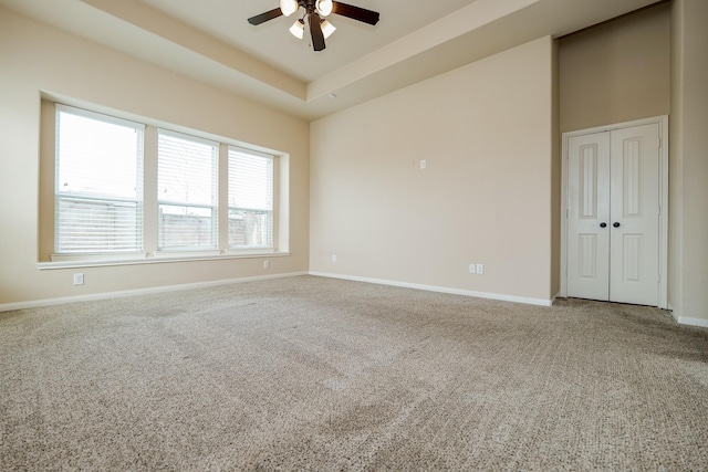 9335 Mystic Falls Ln, Humble, TX 77396 - carpeted spare room featuring a ceiling fan and a tray ceiling
