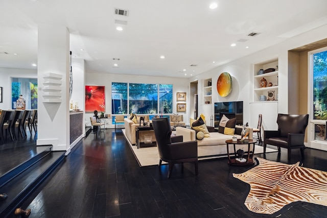2409 Maconda Ln, Houston, TX 77027 - living area with wood finished floors, built in shelves, and recessed lighting
