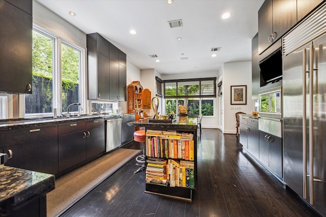 2409 Maconda Ln, Houston, TX 77027 - kitchen with stainless steel appliances, dark wood-style floors, healthy amount of natural light, and recessed lighting
