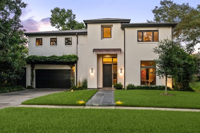 2409 Maconda Ln, Houston, TX 77027 - view of front of home with stucco siding, an attached garage, a standing seam roof, and driveway
