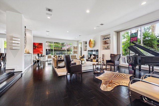 2409 Maconda Ln, Houston, TX 77027 - living area with healthy amount of natural light, wood finished floors, recessed lighting, and built in features