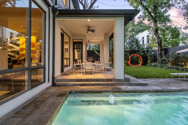 2409 Maconda Ln, Houston, TX 77027 - pool at dusk featuring a ceiling fan and a patio area