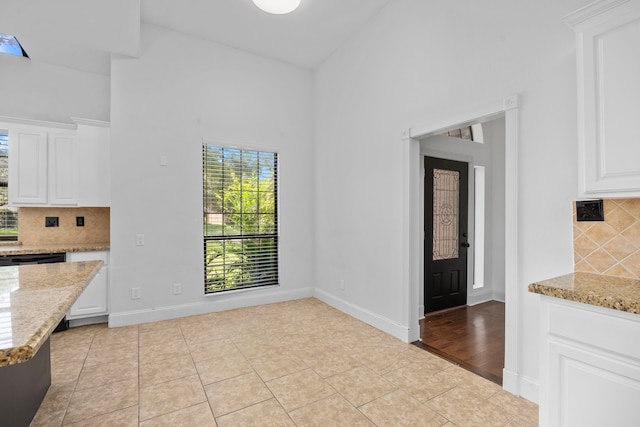 15810 Juneau Ln, Jersey Village, TX 77040 - unfurnished dining area featuring a high ceiling and light tile patterned floors