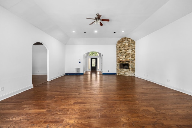 15810 Juneau Ln, Jersey Village, TX 77040 - unfurnished living room with a ceiling fan, vaulted ceiling, arched walkways, wood finished floors, and a fireplace