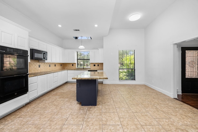 15810 Juneau Ln, Jersey Village, TX 77040 - kitchen featuring black appliances, decorative backsplash, white cabinetry, light stone counters, and recessed lighting