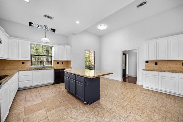 15810 Juneau Ln, Jersey Village, TX 77040 - kitchen featuring black dishwasher, high vaulted ceiling, white cabinets, plenty of natural light, and recessed lighting