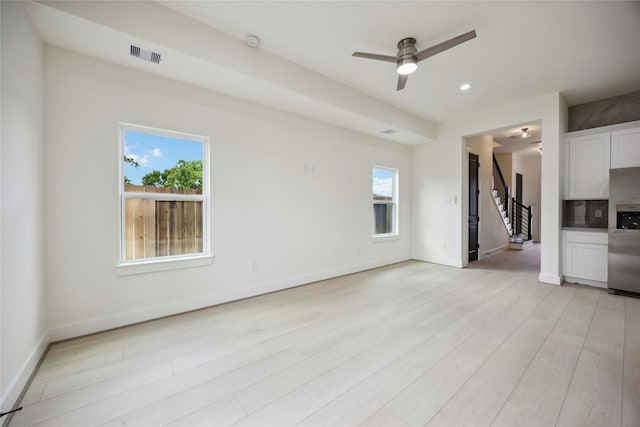 7906 Brandon St, Houston, TX 77051 - unfurnished living room with stairway, plenty of natural light, ceiling fan, light wood finished floors, and recessed lighting