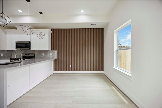 7906 Brandon St, Houston, TX 77051 - kitchen with appliances with stainless steel finishes, decorative backsplash, white cabinetry, light countertops, and recessed lighting