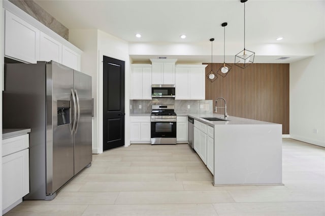 7906 Brandon St, Houston, TX 77051 - kitchen featuring stainless steel appliances, a peninsula, tasteful backsplash, white cabinetry, and recessed lighting