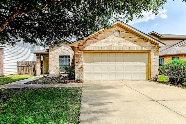 14006 Marners Ct, Houston, TX 77014 - view of front facade featuring an attached garage, concrete driveway, and brick siding