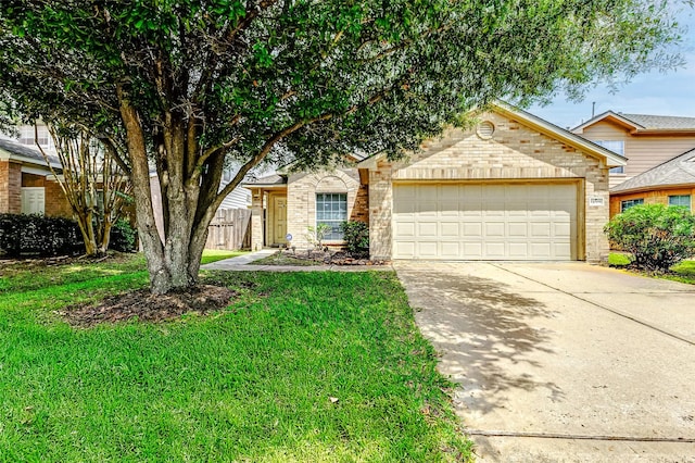 14006 Marners Ct, Houston, TX 77014 - view of property hidden behind natural elements with an attached garage, concrete driveway, a front yard, and brick siding