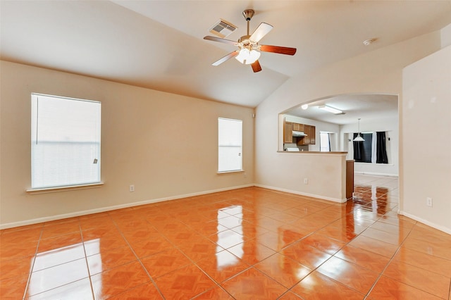 14006 Marners Ct, Houston, TX 77014 - unfurnished living room with light tile patterned floors, vaulted ceiling, arched walkways, and ceiling fan