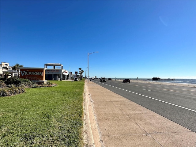 6300 Seawall Blvd Unit 9109, Galveston, TX 77551 - view of asphalt road with street lighting, curbs, and a water view