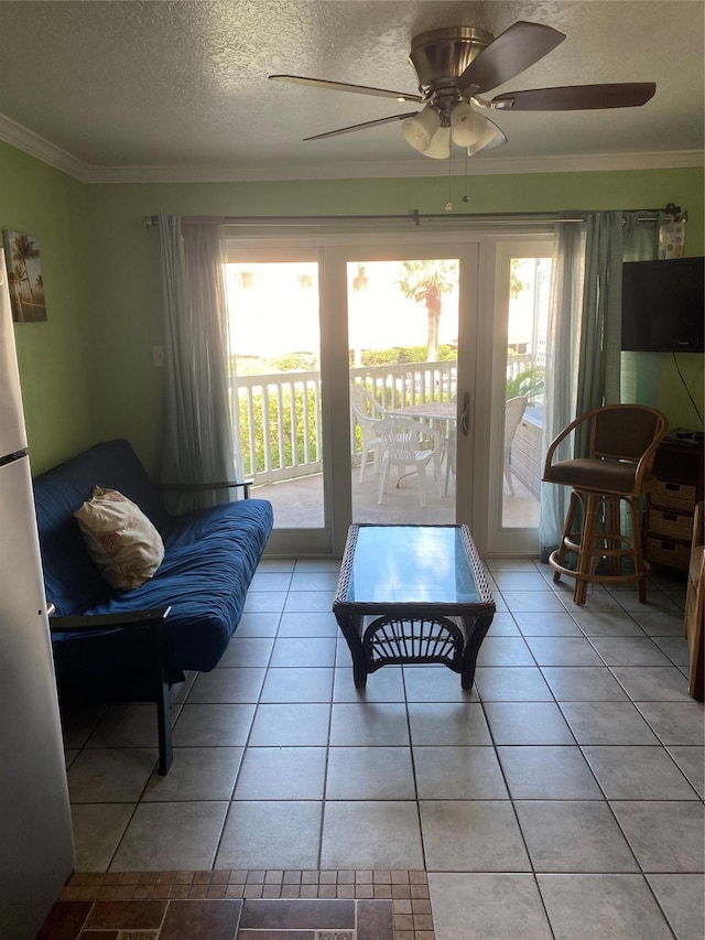 6300 Seawall Blvd Unit 9109, Galveston, TX 77551 - living room featuring plenty of natural light, ceiling fan, ornamental molding, a textured ceiling, and light tile patterned floors