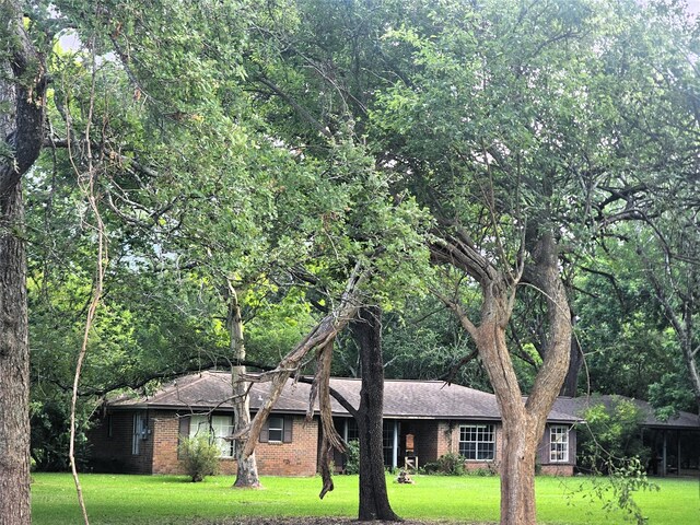 1405 Gou Hole Rd, Cove, TX 77523 - ranch-style house featuring a front lawn, brick siding, and a shingled roof