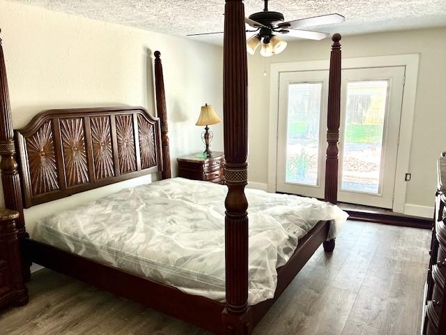 29019 Elmwood Dr, Shenandoah, TX 77381 - bedroom with a textured ceiling, wood finished floors, ceiling fan, and access to outside