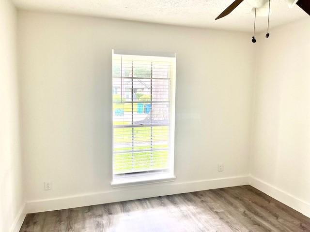 29019 Elmwood Dr, Shenandoah, TX 77381 - unfurnished room featuring ceiling fan and wood finished floors