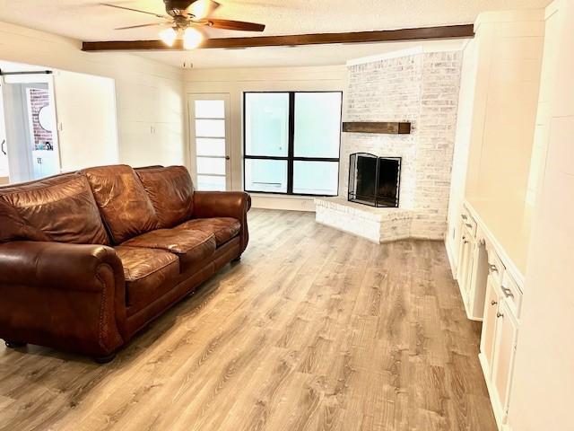 29019 Elmwood Dr, Shenandoah, TX 77381 - living area with light wood-type flooring, ceiling fan, plenty of natural light, and beamed ceiling