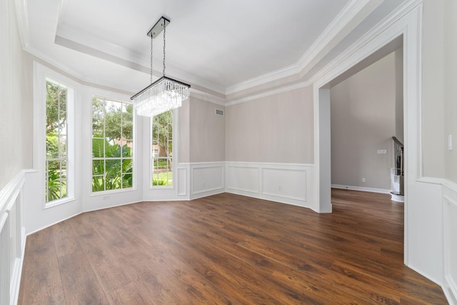 18 Sullivans Ct, Missouri City, TX 77459 - unfurnished dining area with a chandelier, a decorative wall, dark wood-style flooring, a tray ceiling, and crown molding
