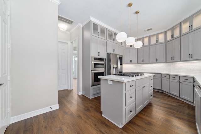 18 Sullivans Ct, Missouri City, TX 77459 - kitchen featuring stainless steel appliances, gray cabinets, tasteful backsplash, a kitchen island, and light countertops