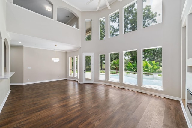 18 Sullivans Ct, Missouri City, TX 77459 - unfurnished living room with plenty of natural light, dark wood-type flooring, a high ceiling, and crown molding