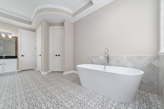 18 Sullivans Ct, Missouri City, TX 77459 - full bathroom with vanity, a freestanding bath, ornamental molding, tile patterned flooring, and tile walls
