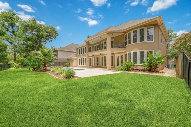 18 Sullivans Ct, Missouri City, TX 77459 - rear view of property with stucco siding, a ceiling fan, a patio, a fenced backyard, and a balcony