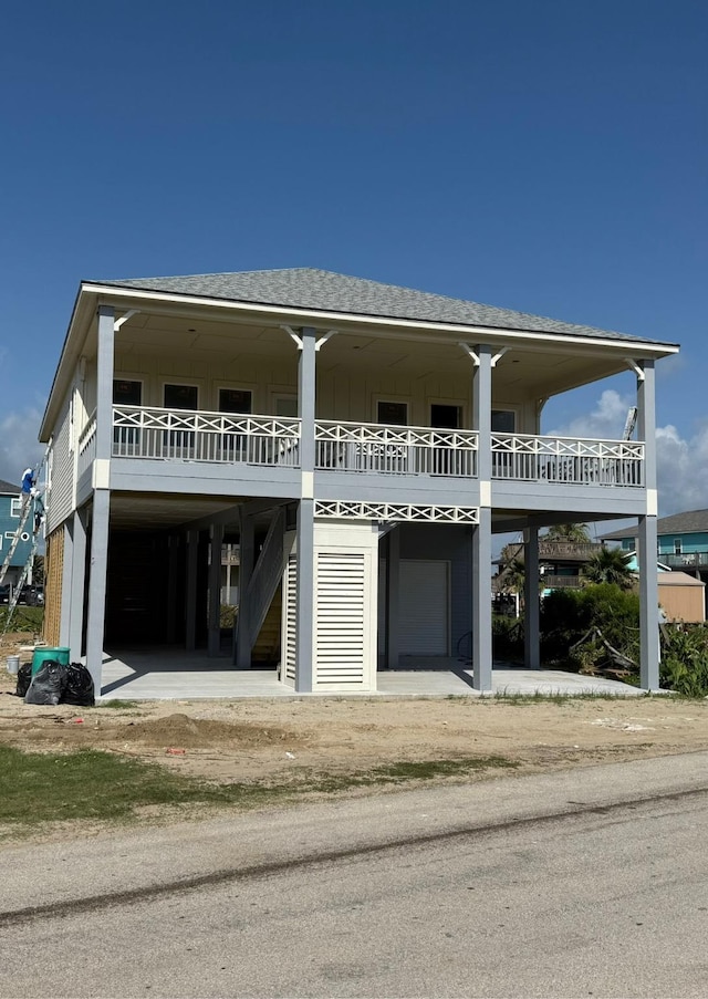 867 Bowers Ln, Crystal Beach, TX 77650 - raised beach house with board and batten siding and roof with shingles