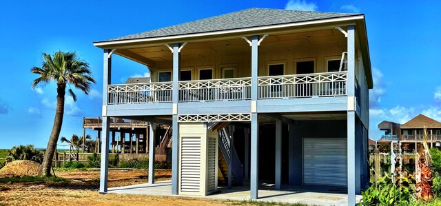 867 Bowers Ln, Crystal Beach, TX 77650 - rear view of property with a carport, board and batten siding, and a shingled roof